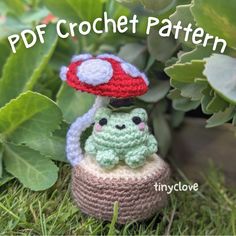 a crocheted mushroom sitting on top of a green plant