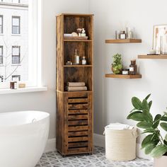 a bathroom with a bathtub, toilet and wooden shelves in the corner next to it