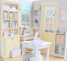 a doll house with lots of furniture and accessories on the table in front of it