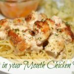 a white plate topped with pasta and meat