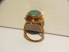 The ring is RC or Cr designed signed on a small gold plate under the stone, the ring is made with solid 14k yellow gold fully stamped, featuring an elegant, twisted rope design with a large natural green Jade Jadeite stone. Stone size 16 x 11 mm, weight 9.0 grams, size 8 in excellent condition. Antique Gold Emerald Cabochon Ring, Antique Gold Round Emerald Ring, Vintage Gold Emerald Cabochon Ring, Antique Yellow Gold Cabochon Emerald Ring, Antique Yellow Gold Emerald Cabochon Ring, Unique Gold Emerald Cabochon Ring, Engraved Emerald Ring In Yellow Gold, Heirloom Gold Emerald Cabochon Ring, Antique Gold Emerald Ring