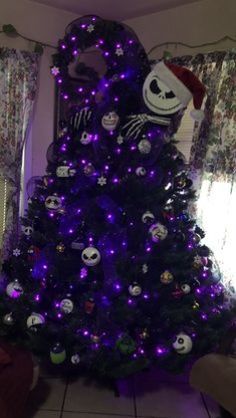 a decorated christmas tree with purple lights