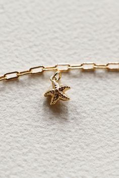 14K Gold filled dotted Starfish charm is sure to remind you of Laguna Beach and is sweet on an ocean themed charm necklace. This is fun yet easy to mix with all other charm styles. Hand make your custom charm necklace in Laguna Beach or build your piece online through adding a base necklace and your selection of charms. Leave us a note on your order for any special requests. Gold filled Tarnish resistant 3D charm Gold Star Charm Necklace For Beach, Gold Charm Necklace With Star Charm For Beach, Gold Charm Necklace With Star For Beach, Ocean-inspired Gold Jewelry With Starfish Charm, Gold Starfish Charm Jewelry, Gold Starfish Charm Necklace Gift, Star Charm Necklace For Beach, Starfish Charms Jewelry For Gifts, Star Charm Necklaces For Beach