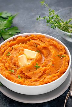 a white bowl filled with mashed sweet potatoes