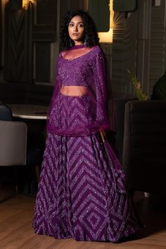 Purple can can attached lehenga skirt with sequin embellished chevron patterns. Comes with matching padded blouse and dupatta.
Components: 3
Pattern: Embroidered
Type Of Work: Cutdana,Sequin
Neckline: V-neck
Sleeve Type: Full
Fabric: Lehenga and Blouse: Georgette, Dupatta: Tulle, Lining: Shantoon, Dupion Silk
Color: Purple
Other Details: 
Attached lining
Length:
Lehenga: 44 inches
Blouse: 15 inches
Closure: Blouse: Back hook
Note: Kindly contact customer service for sleeve customization at an ex Purple Sequin Sharara For Diwali, Bollywood Style Purple Palazzo Set For Party, Eid Sequinned Purple Sets, Eid Purple Sequin Sets, Purple Sequined Sets For Eid, Purple Georgette Sets With Sequins, Purple Sequined Georgette Sets, Traditional Purple Sequined Sets, Bollywood Style Purple Sharara With Sequins