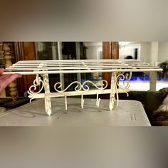 a white iron shelf sitting on top of a table