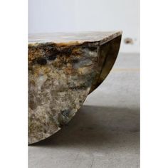 a marble table sitting on top of a cement floor