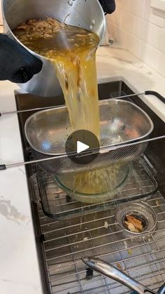 a person pouring something into a bowl on top of a stove