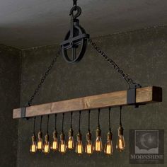 a wooden beam with six light bulbs hanging from it