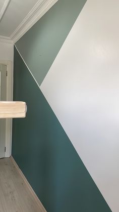 an empty room with green and white paint on the walls