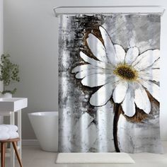 a shower curtain with a white flower on it in a bathroom next to a bathtub