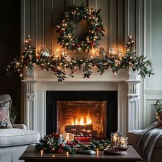 a living room decorated for christmas with candles and wreaths on the fireplace mantel