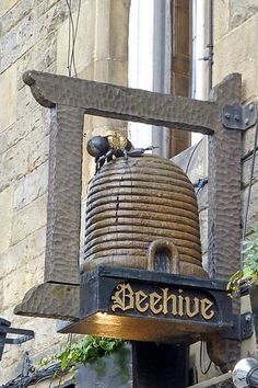 a large bell on the side of a building with a sign that says behemue