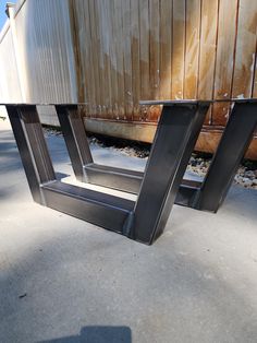 two metal frames sitting next to each other on the ground