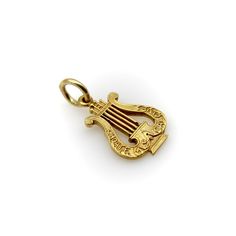 This is part of Chairish’s Fine Jewelry assortment.  This 14k gold pendant is shaped like a musical lyre and inscribed with the words “Choate Musical Clubs.” The charm is most likely associated with Choate Rosemary Hall, a boarding school founded in the 1890’s in Wallingford, Connecticut known for its rigorous academics. The initials “J.W.S.” are engraved on the back of the charm. The gold has an acid wash finish that makes the details of the lyre stand out. The charm was crafted with careful attention to detail, down to the delineation of each individual string.   The charm weighs 1.7 grams. It measures 1/2” x 3/4”.   The perfect charm for a music lover! Wallingford Connecticut, Boarding School, Music Lover, Metal Charm, Harp, Gold Charm, Acid Wash, Connecticut, Charm Jewelry