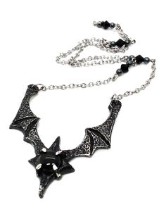 Made to Order! Dramatic, imposing and vampiric as you are, this bat wing necklace will complete your nocturnal ensemble. Stalk the halls of your dwelling or favorite events and capture the attention of your fellow night creatures with its unique design, sculpted in our studio. The pendant is cast in lead free pewter by hand and weathered, then set with a glass or stone cabochon. The chain is accented with hand beaded elements for a finishing touch. It can be layered with one of my rosary chains, or shorter pieces like chokers! Its also perfect on its own with all kinds of outfit choices as a centerpiece. Available in multiple variants Necklace chain default length: 18 in If you'd like a different chain length, please leave a note with your order Time to make and ship: 1-2 days. Gothic Adjustable Necklace For Halloween, Gothic Halloween Adjustable Necklace, Adjustable Black Vampire Style Necklaces, Adjustable Vampire Necklace For Halloween, Adjustable Black Vampire Necklace, Vampire Style Necklace For Halloween, Vampire Style Black Necklace For Halloween, Vampire Style Necklaces For Halloween Cosplay, Adjustable Fantasy Necklaces For Cosplay