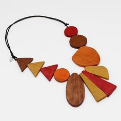 A fun necklace for the art lover. Geometric wood beads are hand painted in rustic orange and browns and stacked together in a unique pattern on an adjustable black wax cord. Wear it long or short, you cant go wrong. Finish your look with coordinating statement earrings or a fun bracelet! Adjustable Length: 24"-38" Care Instructions: Remove jewelry when applying perfumes, creams, washing hands etc. Do not store in direct sunlight. to restore color and shine apply a drop of oil with a soft cloth Rustic Orange, Necklace Orange, Orange Wood, Long Statement Necklace, Fun Bracelet, Bold Necklace, Wood Necklace, Cool Necklaces, Shades Of Orange