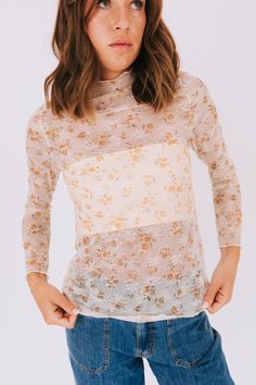 The Bloom All Day Top combines a cozy turtle neck with a feminine touch of floral printed lace and stretchy mesh. Stay chic and comfortable all day long in this playful and versatile top. Available in 2 colors! Details Turtle neck Floral printed lace Stretchy mesh Sizing Approximate measurements: SIZE LENGTH BUST Small 24" 36" Medium 26" 38" Large 26" 40" Fabric has stretchModel is 5’10 wearing small Material 95% Polyester 5% SpandexHand wash coldHang to dry Spring Lace Mesh Top For Layering, Stretch Lace Mesh Top For Spring, Spring Layering Lace Top, Spring Sheer Turtleneck Mesh Top, Sheer Turtleneck Mesh Top For Spring, Spring Turtleneck Mesh Top With Sheer Sleeves, Stretch Floral Print Tops For Layering, Fitted Floral Print Top For Layering, Sheer High Neck Mesh Top For Spring