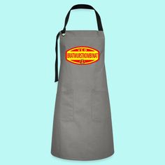 a grey apron with an orange and yellow sticker on the front that says, international kitchen