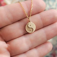 Our minimal tiny solid gold ying yang charm is just one of the many symbols represented in our Tiny Talismans line of spiritual jewelry and gifts. Available in 14k and 18k yellow rose and white gold, as well as platinum--just choose your desired metal from the drop-down menu!  More Tiny Talismans charm necklaces: http://etsy.me/2mtfeSO Details: - Made to order in NYC - Solid 14k, 18k gold or platinum - 11mm wide in diameter and 1.5mm thick. Contact us if you want bigger size. - Default finish is Minimalist Personalized Jewelry For Meditation, 14k Gold Spiritual Round Pendant Charm Necklace, Spiritual 14k Gold Charm Necklace With Round Pendant, Symbolic Hypoallergenic Round Pendant Jewelry, Spiritual Round Charm Necklace In 14k Gold, Spiritual Round 14k Gold Charm Necklaces, Spiritual 14k Gold Round Charm Necklaces, 14k Gold Symbolic Charm Necklace With Round Pendant, Yin Yang Charm