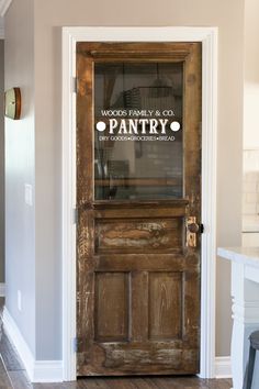 an old wooden door with glass on the front and side paneling in a house