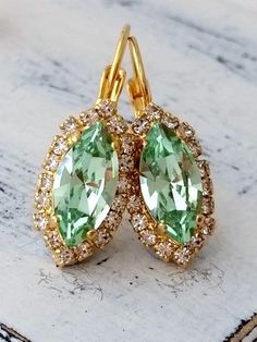 "Mint crystal earrings, Drop earrings, Bright green earring, Bridesmaid gifts, Bridal earring Dangle earrings wedding jewelry, gold or silver Elegant and refined. They would be great as bridal earrings or for any available other day. Perfect gift for bridesmaids or other occasions. They are made of 14k gold plated brass posts and European crystals, all set in prong setting. Made with CRYSTALLIZED™ - high quality genuine European (Austrian) crystals. Total earring's length is 30 mm (1.2 inch) AVA Green Crystal Wedding Earrings With Ear Wire, Green Sparkling Drop Earrings, Green Crystal Drop Earrings For Bridal, Green Sparkling Stone Earrings For Gift, Green Crystal Drop Bridal Earrings, Green Crystal Bridal Earrings As Gift, Green Drop Earrings For Bridesmaid Gift, Wedding Crystal Earrings For May Birthstone, Wedding May Birthstone Drop Crystal Earrings