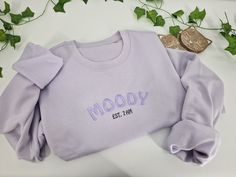 Welcome to our cozy world of comfort and relaxation! Our embroidered sweatshirt is the perfect addition to your wardrobe or makes a great gift for a loved one. - Embroidered sweatshirt - Embroidered to order - High cotton fabric content for the softest feel fabric. 80% Cotton/20% Recycled Polyester. Brushed back fleece. - Unisex sizing for ultimate comfort. Drop shoulder. - Order size up for an over-sized look. - Treat yourself or surprise someone special Hoodies and sweatshirts are embroidered Custom Embroidery Relaxed Fit Sweatshirt For Loungewear, Trendy Letter Embroidery Sweatshirt For Loungewear, Cozy Cotton Sweatshirt With Embroidered Text, Trendy Custom Embroidered Winter Sweatshirt, Casual Sweatshirt With Custom Embroidery For Loungewear, Casual Sweatshirt With Letter Embroidery As Gift, Loungewear Sweater With Letter Embroidery And Relaxed Fit, Relaxed Fit Sweater With Letter Embroidery For Loungewear, Casual Embroidered Sweatshirt For Gift