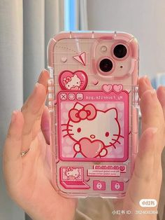 a person holding up a pink case with hello kitty on the front and back sides