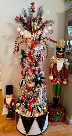 a decorated christmas tree in the corner of a room with nutcrackers and other decorations