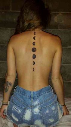 the back of a woman's body with phases on it