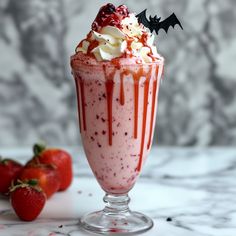 a drink with whipped cream, strawberries and sprinkles