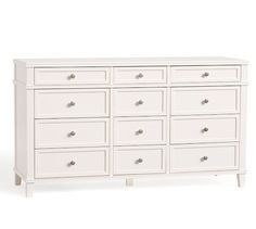 a white dresser with many drawers on it's sides and one drawer in the middle