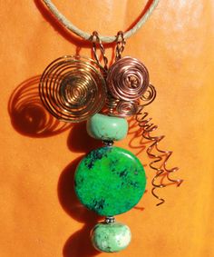 This dazzling polished and beaded jasper & turquoise magnesite wire-embellished pendant, adorned with sterling silver bead spacers, is a unique one-of-a-kind piece of wearable art! Note: the beads rotate, so the focal jasper is in a sense "reversible." With the aid of a small pair of pliers, I've spiraled, coiled, and twisted the 99.9 % pure copper, non-tarnishing and permanently colored wire by hand...no heat or special tools involved! It is already made, ready to ship, and awaiting its new hom Bohemian Jade Jewelry, Bohemian Green Jasper Jewelry, Earthy Turquoise Jewelry For Healing, Green Jasper Spiritual Jewelry, Adjustable Jasper Jewelry In Turquoise, Unique Turquoise Jasper Jewelry, Turquoise Malachite Beaded Jewelry, Nature-inspired Beaded Turquoise Jewelry, Turquoise Beaded Nature-inspired Jewelry