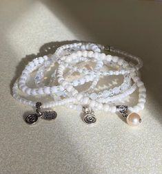 This beautiful set is made with with 4mm & 3mm Miyuki high-quality beads combined with high-quality crystals beads.  We kept in mind that white is often associated with purity, innocence, and simplicity and wearing white beaded bracelets can help you keep hope and stay positive. You can wear each bracelets separately or make a statement by wearing them all together. It is also a wonderful gift for the holidays for brides and bridesmaids. Bohemian Charm Bracelet With White Round Beads, Bohemian White Charm Bracelet With Round Beads, White Crystal Bracelet With Tiny Beads, White Charm Bracelet With Faceted Round Beads, Spiritual White Beaded Charm Bracelet, Spiritual White Beaded Bracelets With Tiny Beads, White Dainty Bracelet With Faceted Beads, Dainty White Bracelets With Faceted Beads, Dainty White Bracelet With Faceted Beads