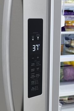 a stainless steel refrigerator with the door open and it's temperature displayed on its side