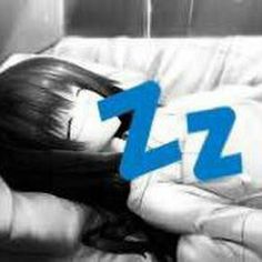 a woman laying on top of a white couch next to a blue zzz logo