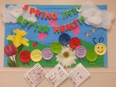 a bulletin board with buttons and flowers on it that says spring into better health next to three calendars