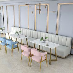 a dining room with several tables and chairs in pastel colors, along with two planters on the wall