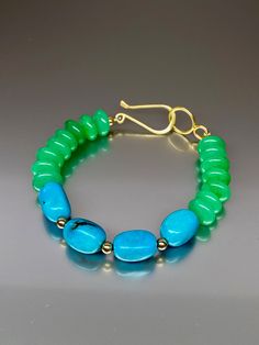 Beautiful chrysoprase green chalcedony and Mexican nacozari turquoise bracelet. The gorgeous color combination of fine quality vivid blue Mexican nacozari turquoise with chrysoprase green chalcedony creates a colorful bracelet. A small 14k gold-filled beads were added in-between the green chalcedony beads ending with a gold vermeil clasp. The necklace Length (with clasp)is about 8 inches long. Chic and colorful bracelet. *Metal: 14K Goldfilled, vermeil (over sterling silver) *Earrings drop lengt Green Cabochon Bracelets As A Gift, Green Cabochon Bracelets For Gift, Turquoise Gemstone Beaded Bracelets In Jade, Turquoise Jade Beaded Bracelets, Turquoise Jewelry With Natural Stones In Green Onyx, Turquoise Jewelry With Natural Green Onyx Stones, Turquoise Jade Gemstone Bracelet, Turquoise Gemstone Jewelry With Green Onyx, Turquoise Chalcedony Jewelry With Natural Stones