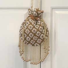 The Mindy Potli Bag with it's beautiful design made of stones, pearls and zardozi embroidery, will elevate the look of any outfit.   The hanging tassels add the perfect final touch of bling to this gorgeous design.  (Comes in 4 colors) Elegant Potli Bag With Tassels For Reception, Traditional Bags With Tassels For Reception, Traditional Tassel Bags For Reception, Gold Potli Bag With Latkans For Reception, Festival Potli Bag With Latkans For Reception, Festive Potli Bag With Latkans For Receptions, Festival Reception Potli Bag With Latkans, Traditional Bags With Latkans For Reception, Traditional Embellished Pouch Bag