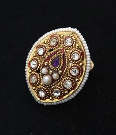 Gorgeous gemstone statement ring will wow at your next festive occasion 22k Yellow gold hypoallergenic, nickle and lead free Red enamel detail Pearl, Kundan and Amethyst gemstone Adjustable, one size fits most Gold Rings With Stone Work For Festive Occasion, Festive Gold Rings With Stone Work, Elegant Gold Ring With Stone Work, Gold Ring With Stone Work, Jeweled Open Ring Jewelry Gift, Gold Crystal Ring With Stone Setting For Wedding, Oval Jeweled Rings For Weddings, Yellow Gold Ring For Celebration, Oval Jeweled Wedding Rings