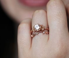 a close up of a person's hand with a ring on it