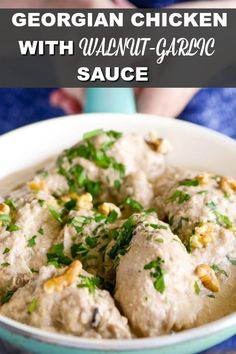 a white bowl filled with meatballs and garnished with parsley on top