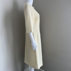 Vintage Adrian TabinUS Vintage Women's Size 16 (This is not a modern day size 16, please see the measurements below, it is smaller than modern 16)The detail work on this vintage mohair and wool dress is gorgeous. The overlay is made of a light yellow/ivory fine crochet texture with boucle detail at the collar and wrist. It has an ivory colored Talon brand zipper down the back. It is lined with an ivory acetate fabric. The sleeves are not quite 3/4 length. There is a belt loop on one side but it is missing on the other. I have left it as it was so you can decide what to do with it. This is a fairly conservative style with the crewneck line. I could see someone wearing this with a pillbox hat and some gloves. It is in very good vintage condition. Please see pictures for details and material Cream Fitted Long Sleeve Vintage Dress, Fitted Long Sleeve Cream Vintage Dress, Elegant Cream Vintage Dress For Daywear, Cream 1950s Style Dresses, Vintage Beige Dress For Winter, Vintage Beige Winter Dress, Vintage Beige Dresses For Winter, Cream Retro Vintage Dress For Formal Occasions, Spring Vintage Cream Dress For Formal Occasions