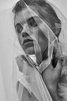 black and white photograph of a woman wearing a veil