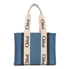 This is an authentic CHLOE Denim Shiny Calfskin Medium Woody Ribbon Tote in Navy. This chic tote is crafted of blue denim with blue leather trim. The bag features black Chlo logos vertically on the white fabric trim that extent into the top handles with navy leather accents. The top is open to a matching fabric interior with a patch pocket. Chloe Logo, Denim Tote, Leather Accents, Denim Bag, Navy Leather, Chloe Bag, Fabric Trim, White Fabric, Blue Bags