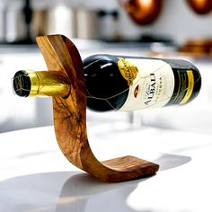 a wine bottle holder made out of wood