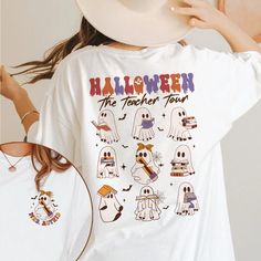 Teacher Halloween Shirt, Personalized Teacher Shirt, Teacher Appreciation Gift, Retro Teacher Shirt, Fall Shirt, Ghost Halloween Shirt 🌟 Greetings, Esteemed Customers! 🌟 We want to express our sincere appreciation for visiting our page. Highlandreign is a boutique-style business owned by women, committed to providing exceptional quality and service to our valued clientele. Discover our exquisite selection of designs crafted exclusively for you. Indulge in the luxury of personalized t-shirts fo White Fan Merchandise T-shirt For Fall, White Fall Fan Merchandise T-shirt, Fun Fall Fan Merchandise T-shirt, Fall Fan Merchandise Fun T-shirt, Fun Fan Merchandise T-shirt For Fall, White Long Sleeve Halloween T-shirt, White Long Sleeve T-shirt For Halloween, White Halloween Shirt With Letter Print, White Halloween Shirt With Custom Print