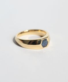 Raw hexagonal sapphire set in 14k yellow gold wide band. Specifications: Solid 14k yellow gold. Approx 6mm sapphire. Band measures 6mm at front, 3mm at back. Custom sized in approx. 10-14 days. Contact us for rush orders. 14k Gold Octagon Rings With Polished Finish, Modern Gold Sapphire Ring With Polished Finish, Octagon Sapphire Ring In Yellow Gold As Gift, Gold Sapphire Rings With Asscher Cut, Gold Sapphire Asscher-cut Ring, Gold Asscher Cut Sapphire Rings, Modern Octagon Sapphire Ring, Gold Octagon Sapphire Jewelry, Octagon Sapphire Ring In Yellow Gold