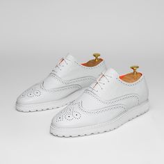 The Priority Leather White Low Top Leather Sneaker With Soft Foam Sole.. Made With Premium Soft Leather Upper. Made With Soft Mesh Lining And Removable Soft Insole For Comfort. Toe Shape Round Pattern Wingtip Closure Lace Up Width Wide Upper Mat Leather Upper Color White Lining Mat Mesh Lining Color Orange Insole Mat Foam Insole Color Orange Welt Mat Rubber Welt Color White Sole Mat Foam Sole Color White White Leather Lace-up Shoes With Textured Sole, White Plain Toe Lace-up Shoes For Derby, White Lace-up Shoes With Brogue Detailing, White Dress Shoes With Brogue Detailing For Spring, White Leather Shoes With Textured Sole And Lace-up, White Wingtip Lace-up Casual Shoes, White Lace-up Leather Shoes With Textured Sole, White Lace-up Shoes With Textured Sole And Plain Toe, White Brogue Lace-up Shoes With Round Toe